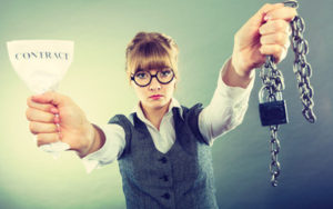 A woman holding chains and a lock as well as a sign saying contract