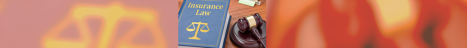 Insurance law book and judge's gavel