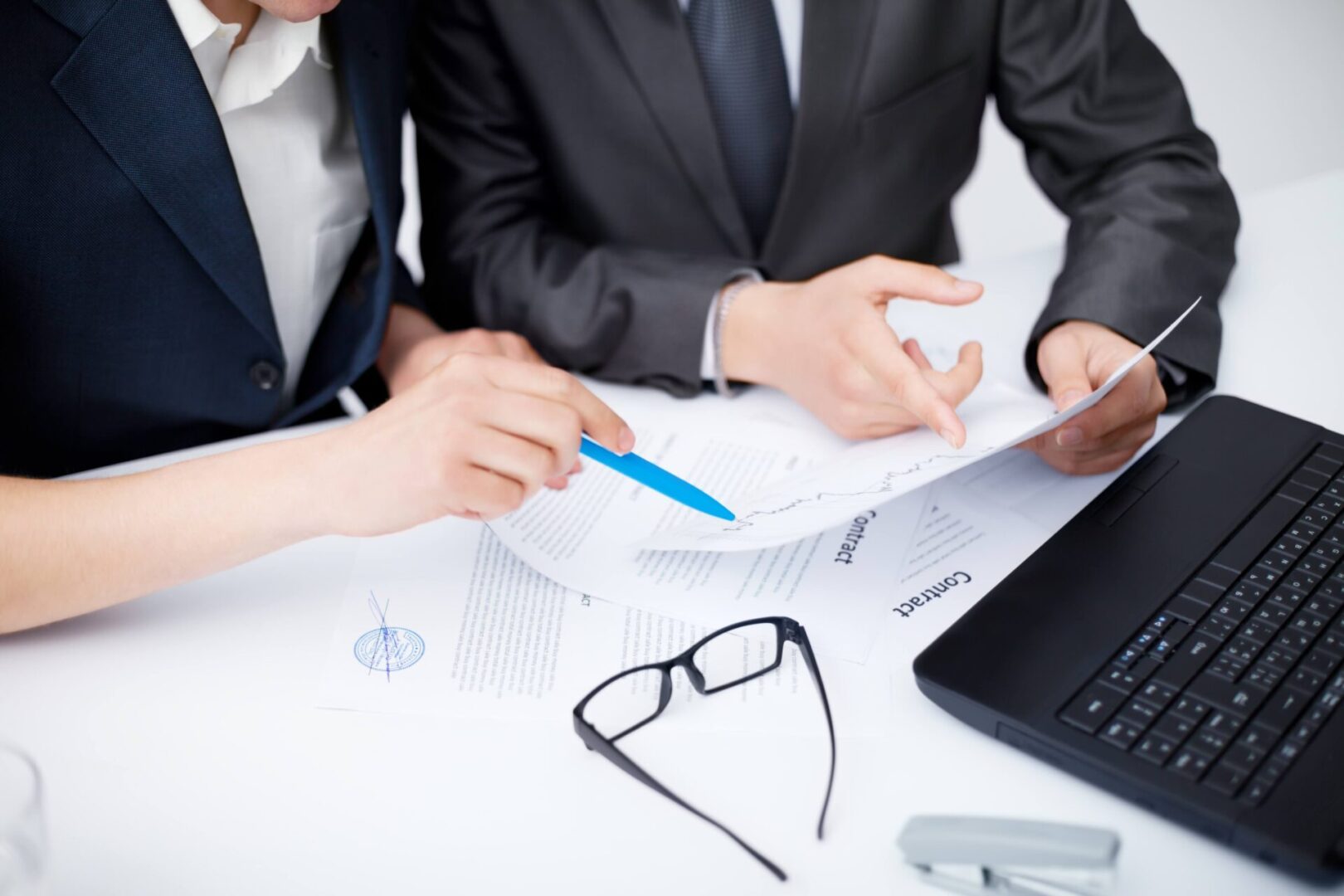 Two people discussing a document