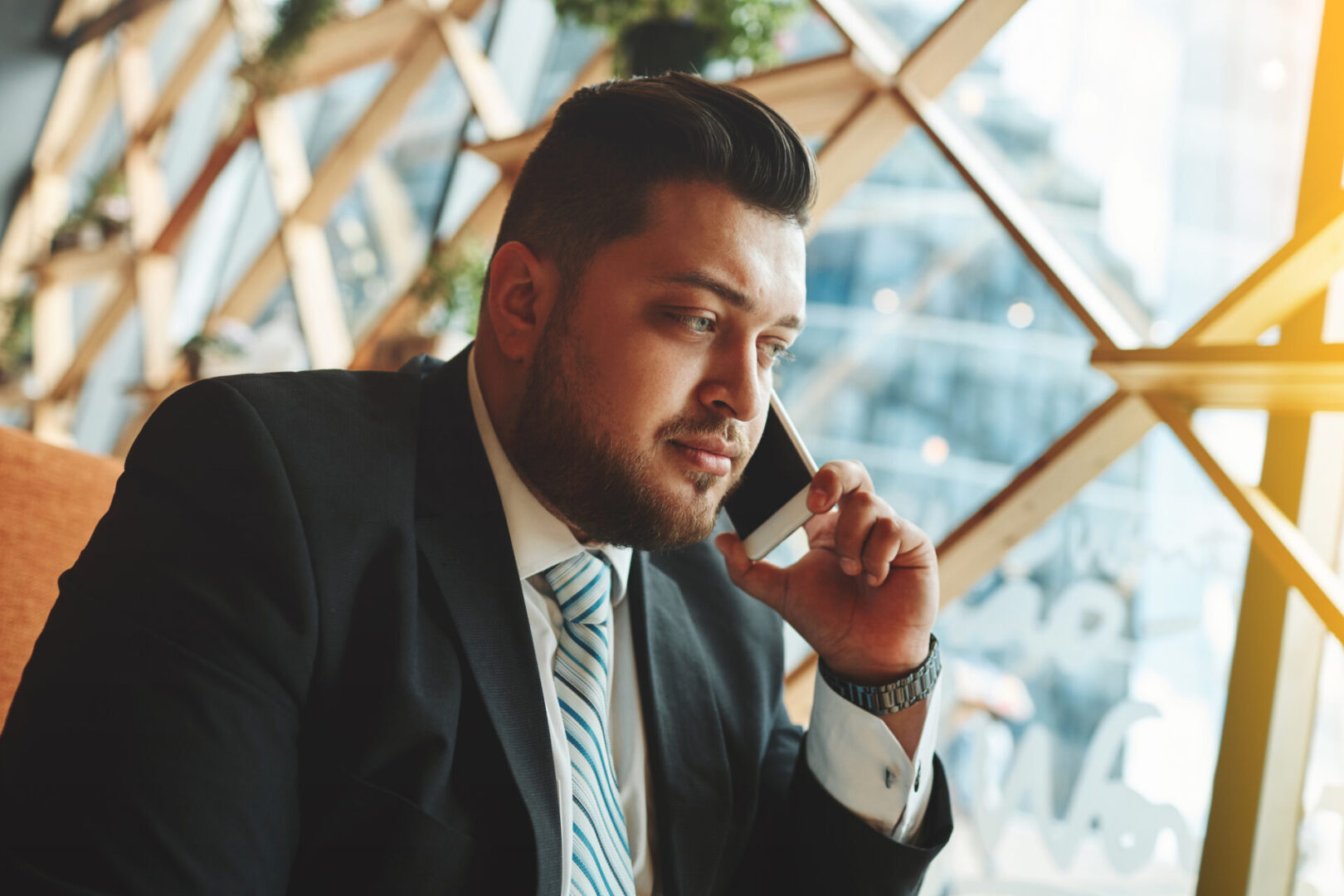 A Man in a Black Color Suit With a Phone